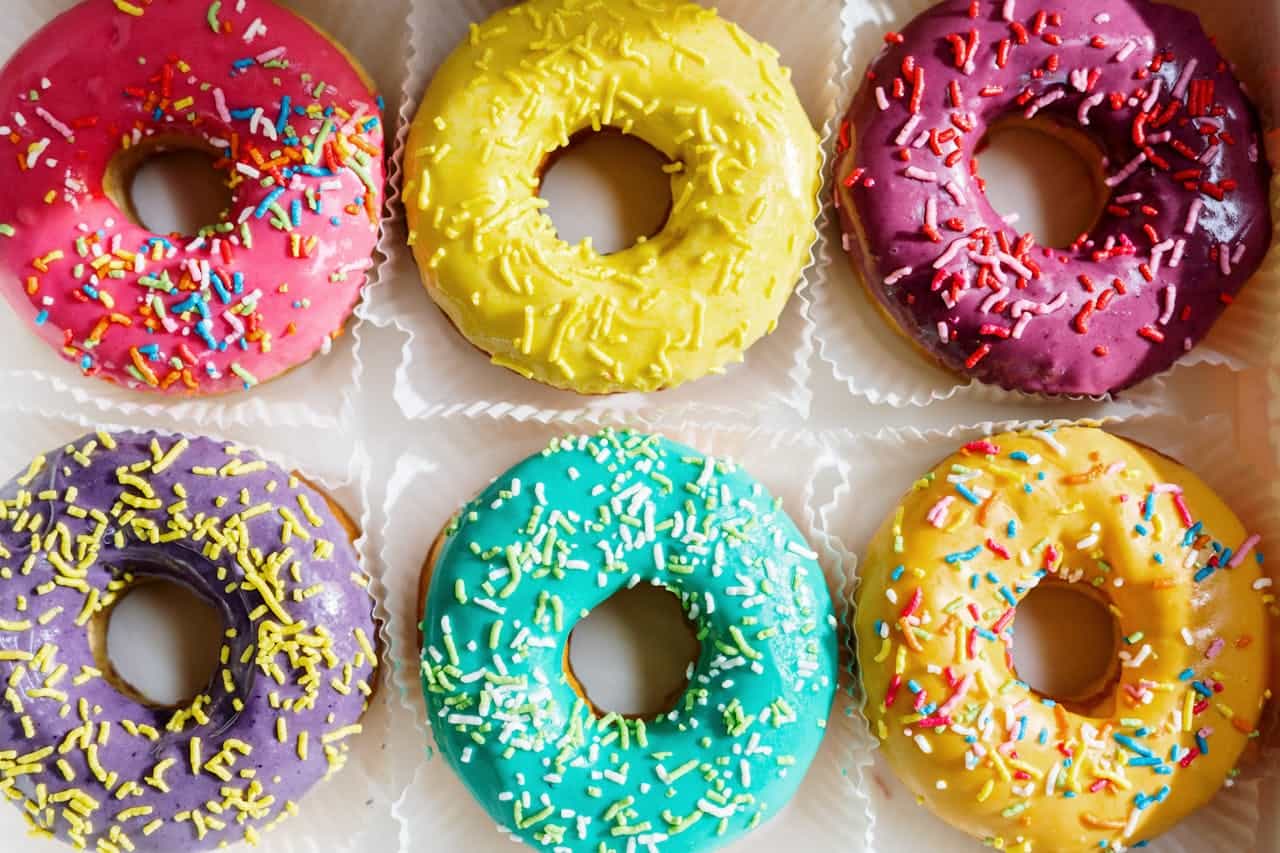 Photo by cottonbro studio: https://www.pexels.com/photo/pink-doughnut-on-white-textile-4686960/