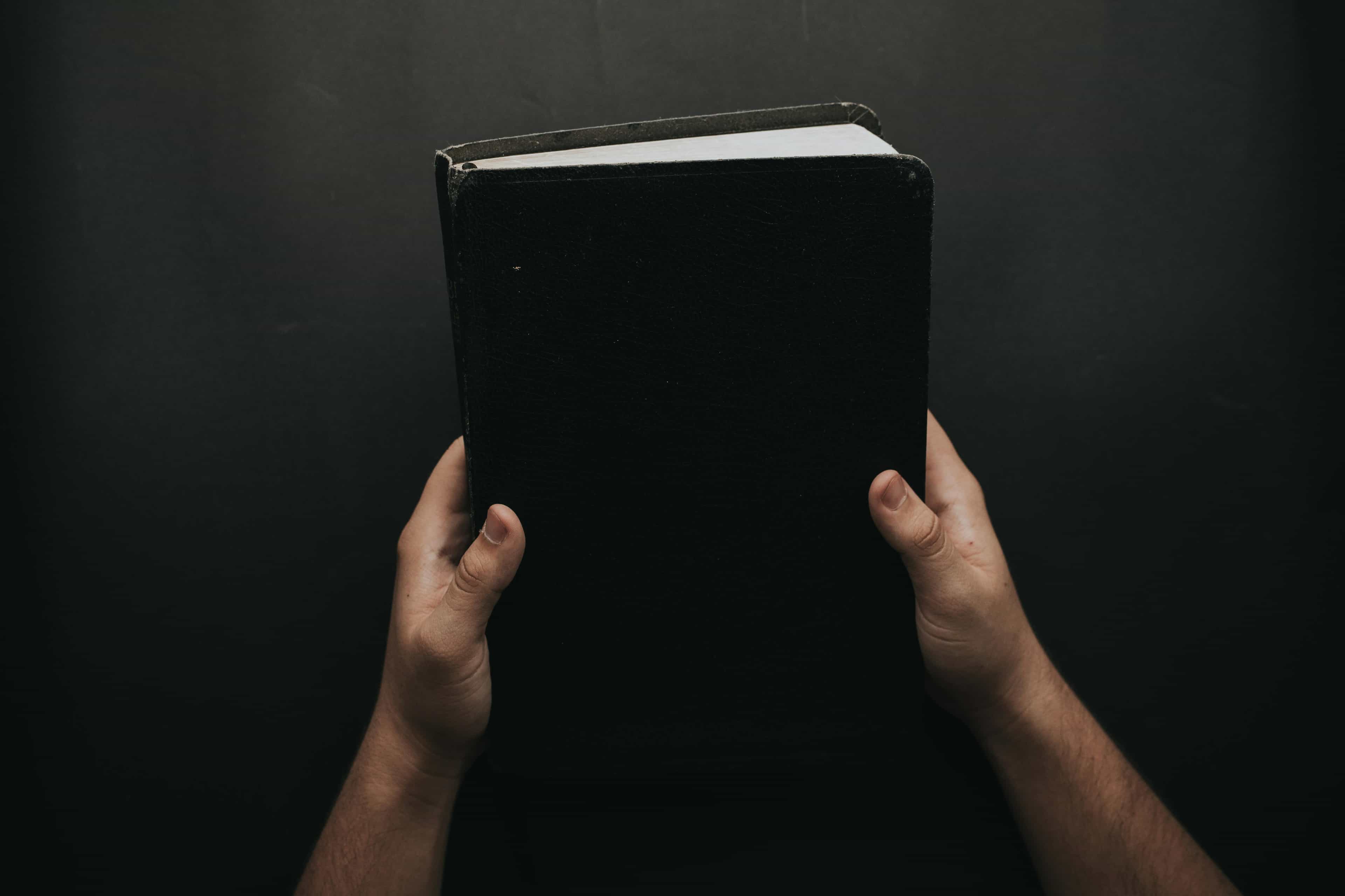 Photo by Luis Quintero from Pexels: https://www.pexels.com/photo/person-holding-black-cover-bible-2258240/
