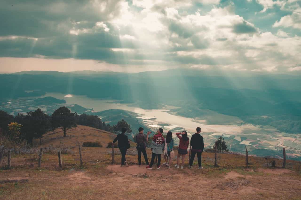 Photo by Min An: https://www.pexels.com/photo/group-of-people-standing-near-fence-977460/