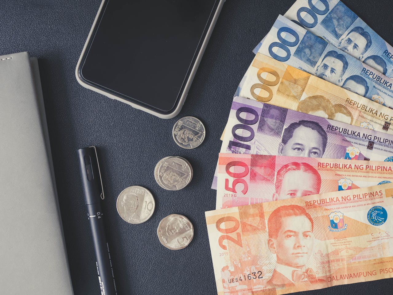 Photo by Angie Reyes: https://www.pexels.com/photo/philippine-money-on-black-surface-6921969/