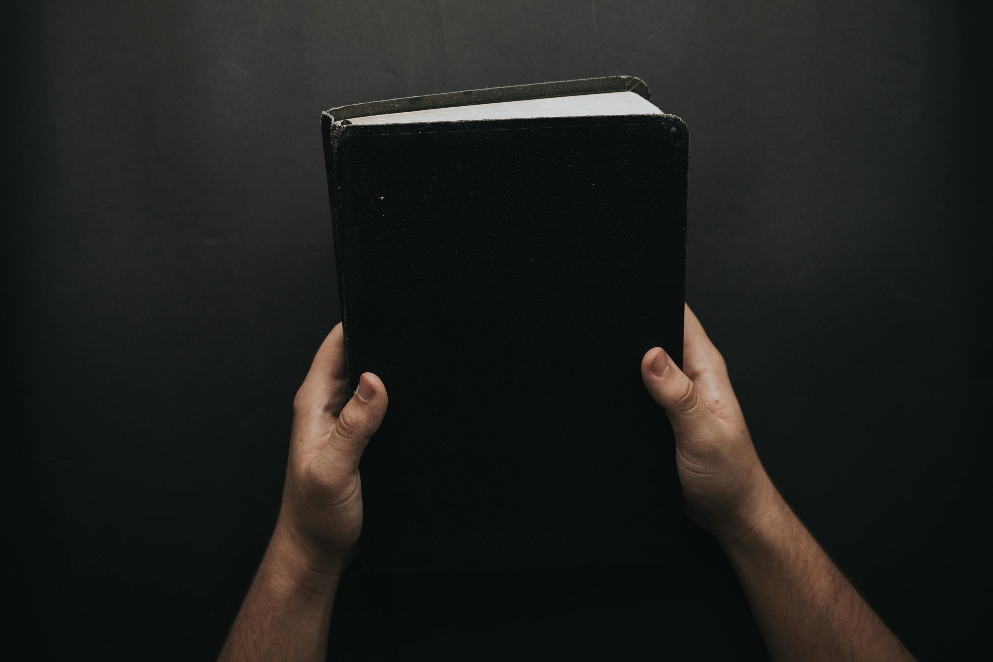 Photo by Luis Quintero from Pexels: https://www.pexels.com/photo/person-holding-black-cover-bible-2258240/