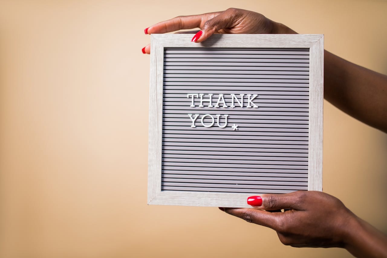 Photo by RDNE Stock project: https://www.pexels.com/photo/a-person-holding-a-gray-thank-you-signage-7563672/