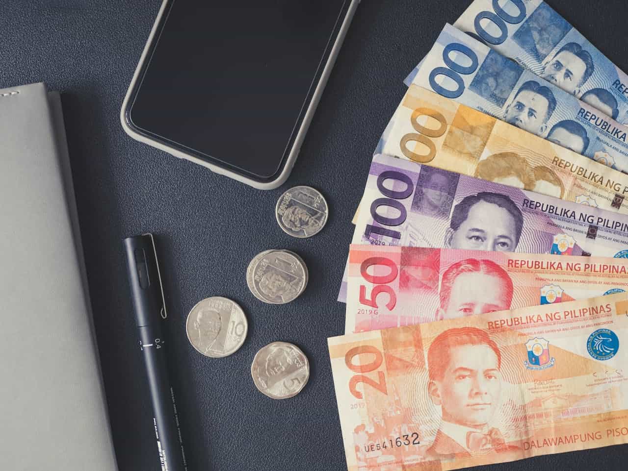 Photo by Angie Reyes: https://www.pexels.com/photo/philippine-money-on-black-surface-6921969/