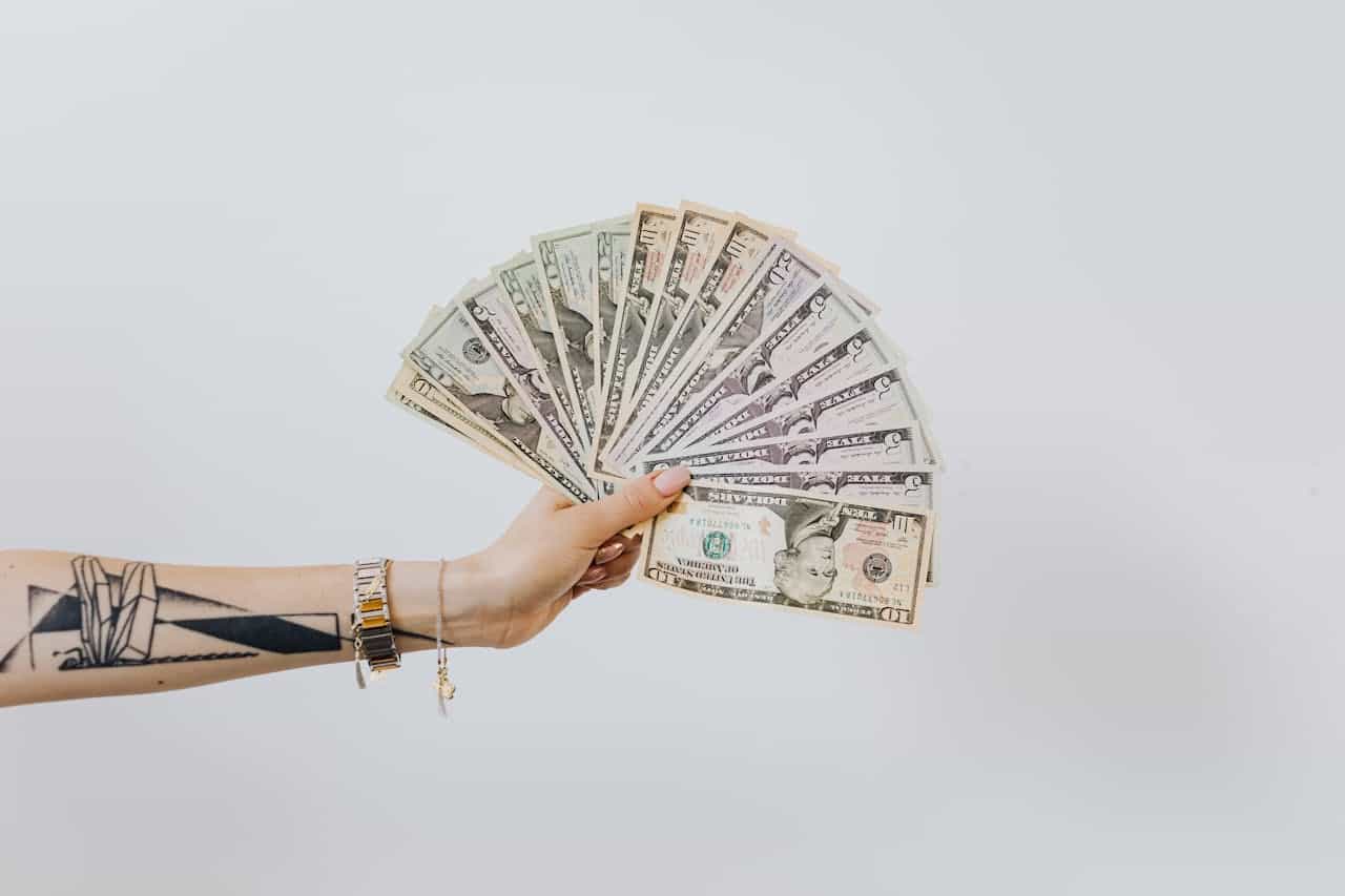 Photo by Karolina Grabowska from Pexels: https://www.pexels.com/photo/hand-holding-fan-of-us-dollar-bills-4968663/